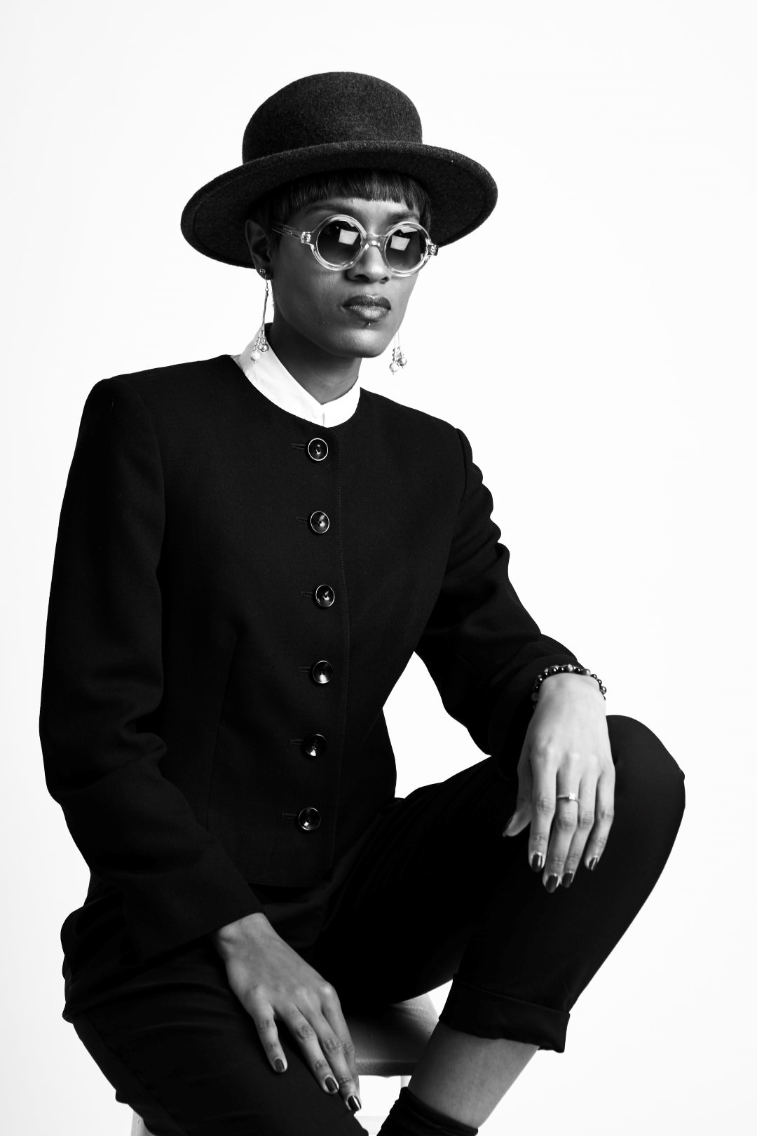 Donya Patrice from the style siblings posing in a suit and hat